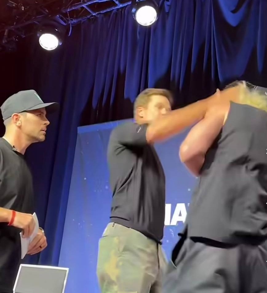 Tom Brady and Logan Paul standing on stage